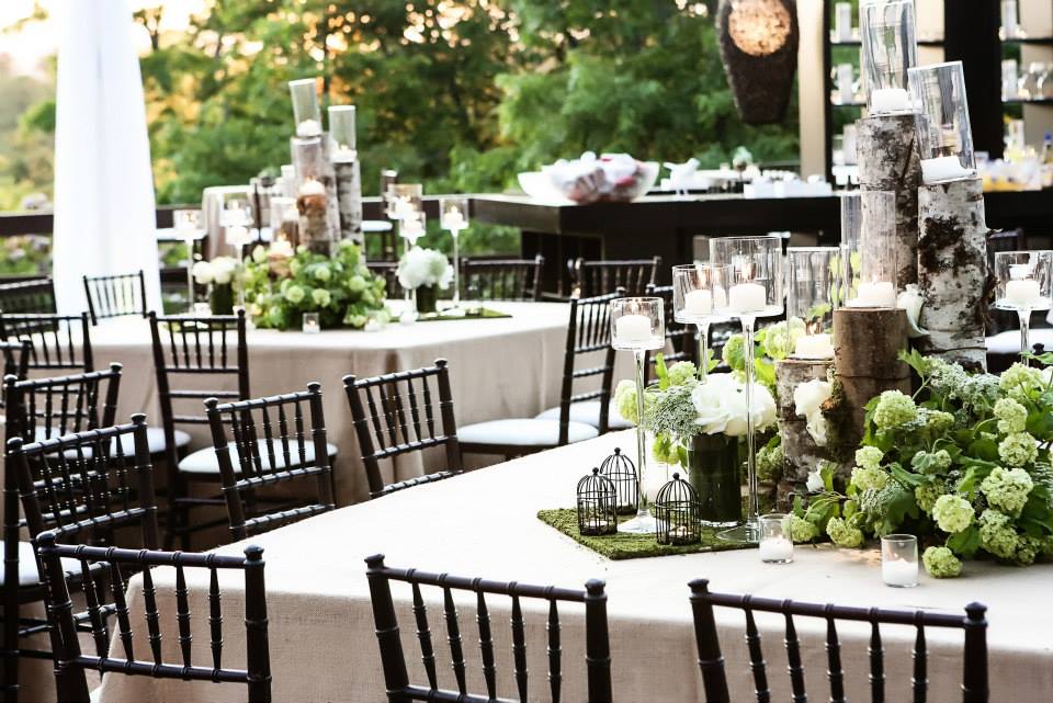Branch Centerpiece with Candles and Crystal Accents over Black Tablecloth –  shared by Wedding Design Studio